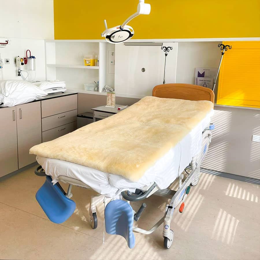 Ziekenhuisbed met een medicinaal gelooide schapenvacht onderdeken